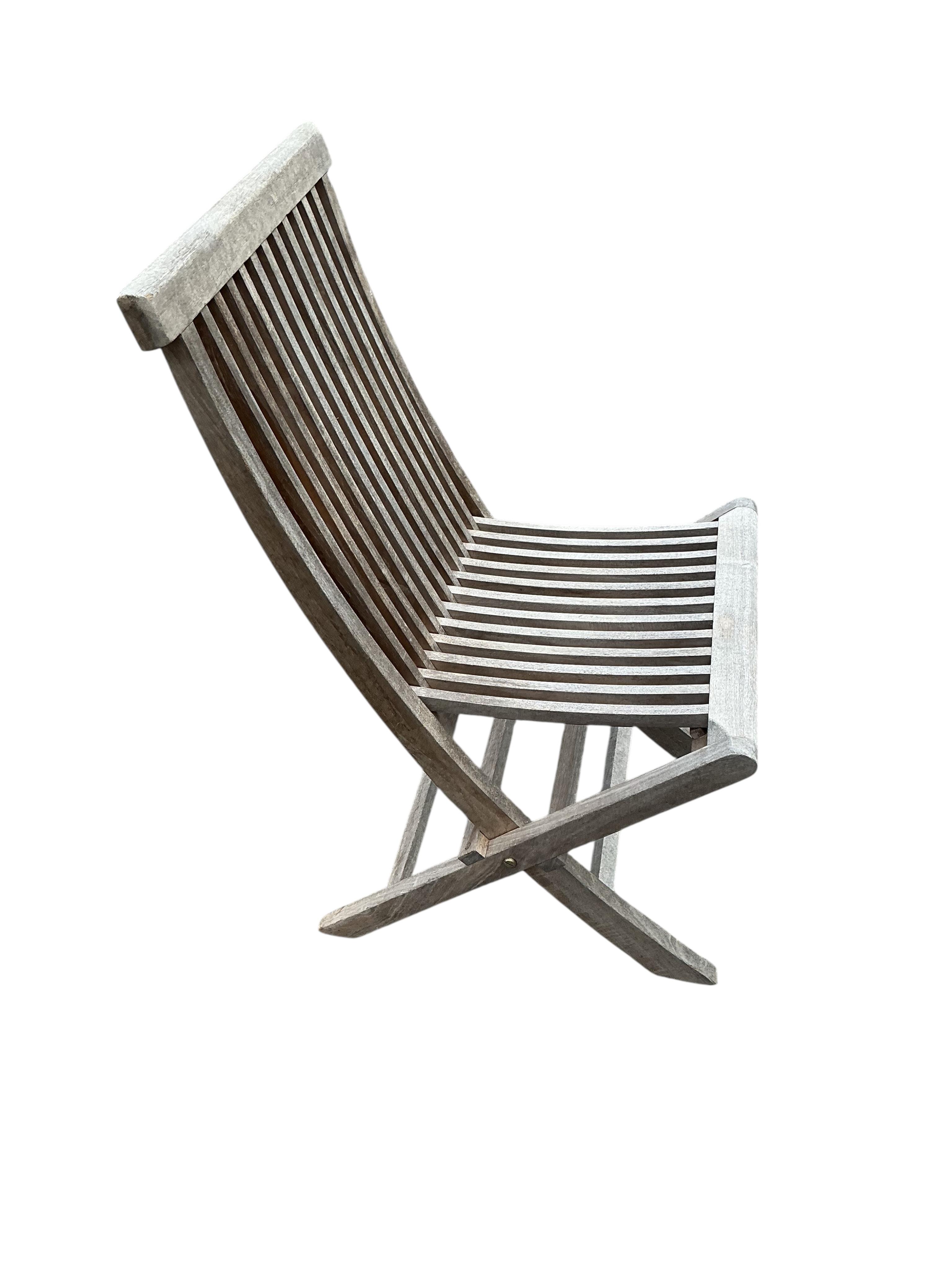 Twelve teak folding garden chairs